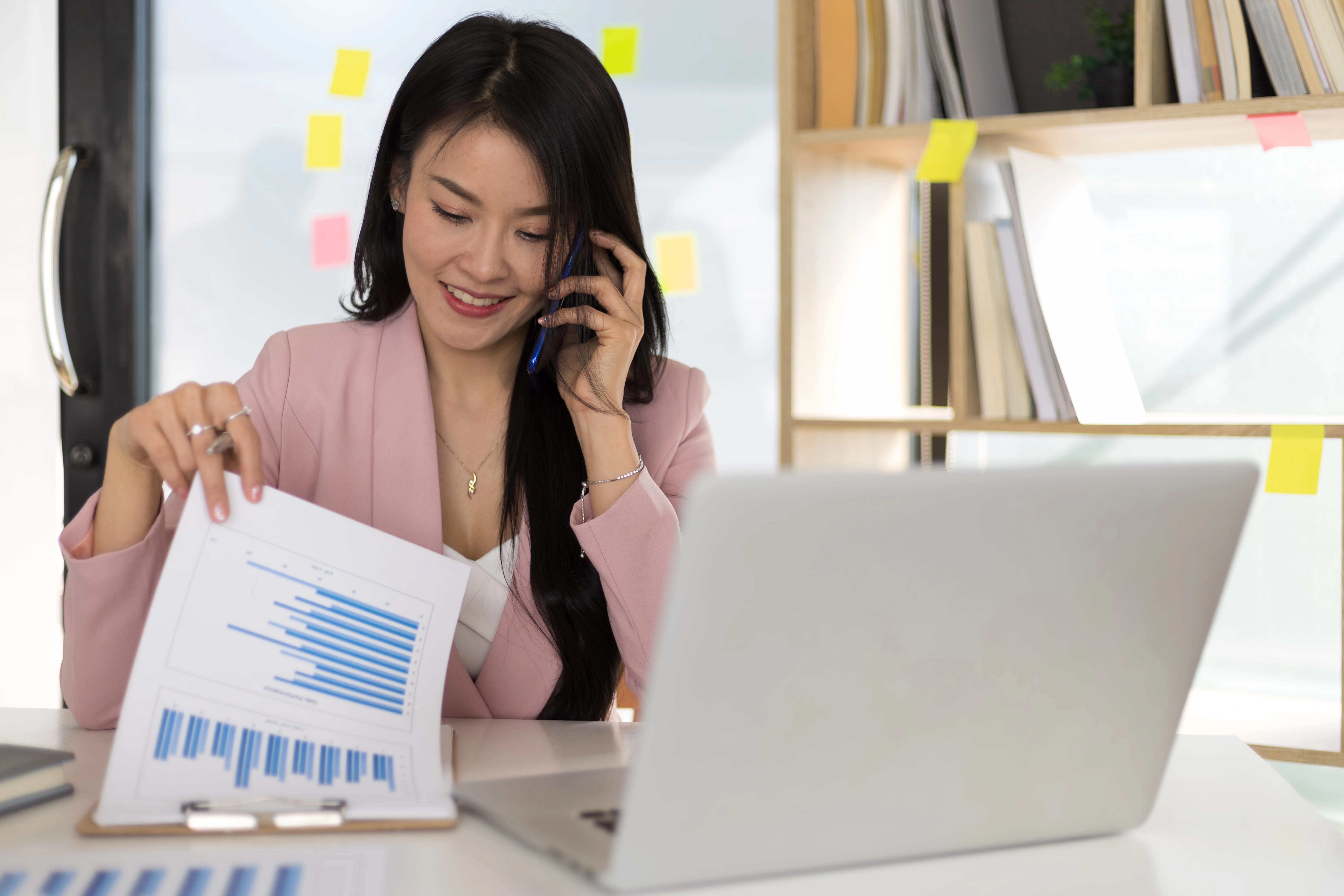 Business woman in the office working on the audit of business reports and auditing documents.